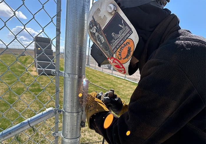 SWi Fence team welding a chain link gate